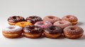 Assorted mini donuts with colorful toppings on a light background