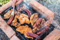 Assorted mixed meat on a barbecue grill on a sunny summer day