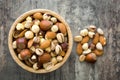 Assorted mixed nuts in bowl on wooden table Royalty Free Stock Photo