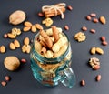 Assorted mixed nuts in a glass jar, peanuts, almonds, walnuts and sesame seeds Royalty Free Stock Photo