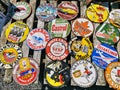 Assorted motor vehicle industry related brand badges for sale on a wooden base