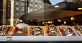 Assorted mouth-watering Belgian waffles in a shop window. Panorama format