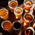 Assorted mugs and glasses of beer ale on wooden tabletop in pub and bar Royalty Free Stock Photo