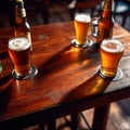 Assorted mugs and glasses of beer ale on wooden tabletop in pub and bar Royalty Free Stock Photo