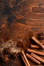 Assorted natural cinnamon, cane brown sugar, ground coffee, anise stars baking ingredients on a rustic brown