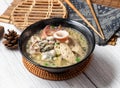 Assorted noodle soup in a dish isolated on wood table side view taiwan food