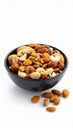 Assorted nuts in a black bowl on a white background healthy snack food Royalty Free Stock Photo