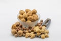 Assorted nuts in a glass bowl and isolated nutcrackers on a white background Royalty Free Stock Photo