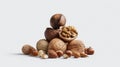 Assorted nuts including walnuts, hazelnuts, almonds and coconut arranged in artistic pyramid composition on white background for Royalty Free Stock Photo