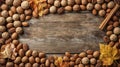 Assorted walnuts, pecans, almonds, and hazelnuts on rustic wooden table with autumn leaves, organic healthy seasonal snack. Royalty Free Stock Photo