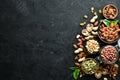 Assorted nuts on the old black background. Royalty Free Stock Photo