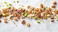 Assorted Nuts and Pistachios Scattered on Marble Surface Royalty Free Stock Photo
