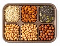 Assorted Nuts Seeds and Chickpeas Displayed on a Brown Tray Against a White Background Royalty Free Stock Photo