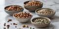 Assorted Nuts and Seeds Displayed in Rustic Bowls on Marble Surface Royalty Free Stock Photo