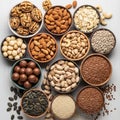 Assorted nuts and seeds are presented in small bowls on a light wooden surface Royalty Free Stock Photo