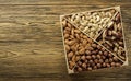 Assorted nuts. Set of nuts top view. Wooden table top. Texture background. Place for advertising text Royalty Free Stock Photo