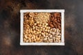 Assorted nuts in a white wooden box on a dark texture background. Royalty Free Stock Photo