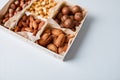 Assorted nuts in a wooden box nuts: pecan, almond, macadamia, brazil, cashew