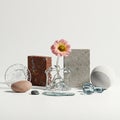 Assorted objects arranged on a surface include a cracked glass circle, a smooth pink