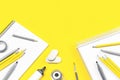 Assorted office and school stationery office supplies on yellow