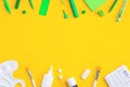 Assorted office and school white and green stationery on yellow