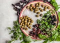 Assorted olives on the ceramic plate with different greens Royalty Free Stock Photo