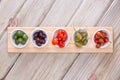 Assorted olives and peppers on taster plates Royalty Free Stock Photo