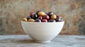 Assorted olives in a white bowl with a rustic background Royalty Free Stock Photo