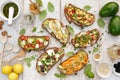 Assorted open faced sandwiches, Open avocado sandwiches made of slices of sourdough bread with various toppings on a white wood