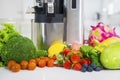 Assorted organic fruits with juicer machine