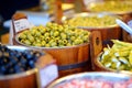 Assorted organic pickled olives, garlic, hot peppers, capers and sundried tomatos sold on a marketplace in Vilnius, Lithuania Royalty Free Stock Photo