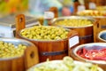 Assorted organic pickled olives, garlic, hot peppers, capers and sundried tomatos sold on a marketplace in Vilnius, Lithuania Royalty Free Stock Photo