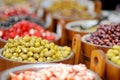 Assorted organic pickled olives, garlic, hot peppers, capers and sundried tomatos sold on a marketplace in Vilnius, Lithuania, Royalty Free Stock Photo