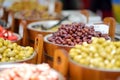 Assorted organic pickled olives, garlic, hot peppers, capers and sundried tomatos sold on a marketplace in Vilnius, Lithuania, Royalty Free Stock Photo