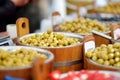 Assorted organic pickled olives, garlic, hot peppers, capers and sundried tomatos sold on a marketplace in Vilnius, Lithuania, Royalty Free Stock Photo