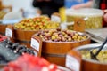 Assorted organic pickled olives, garlic, hot peppers, capers and sundried tomatos sold on a marketplace in Vilnius, Lithuania, Royalty Free Stock Photo