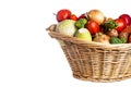 Assorted organic vegetables and fruits in wicker basket isolated on white background. Space for text Royalty Free Stock Photo