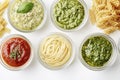 Assorted pasta with sauces and pesto in glass bowls on white background Royalty Free Stock Photo