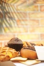 Assorted pastries in outdoor cafe, brick wall on a backdrop