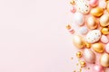 Assorted Peach and Gold Easter Eggs Arranged on Solid Pink Background. Top view Royalty Free Stock Photo