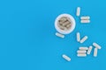 Assorted pharmaceutical medicine pills, tablets and capsules and bottle on blue background. Copy space Royalty Free Stock Photo