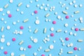 Assorted pharmaceutical medicine pills, tablets and capsules. medical pattern on a blue background. Royalty Free Stock Photo