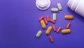 Assorted pharmaceutical medicine pills, tablets and capsules. Pills on purple background. Royalty Free Stock Photo