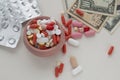Assorted pharmaceutical pills, empty blister packs and dollar bills