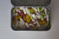 Assorted pills in a metal box on a white background Royalty Free Stock Photo