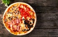 Assorted Pizza with bacon, mushrooms, peppers and olives on the Royalty Free Stock Photo