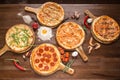 Assorted pizza with seafood and cheese, four cheeses, pepperoni, meat, margarita on a wooden stand with spices