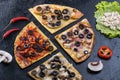 Assorted pizza slices. Margherita, pepperoni, four cheese pizza. Top view. Different types of pizza on the textured old Royalty Free Stock Photo