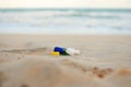 Assorted plastic bottle caps on the sand at a beach in Brazil, Ocean Microplastic Pollution