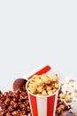 Assorted popcorn set in paper striped white red cup. Royalty Free Stock Photo